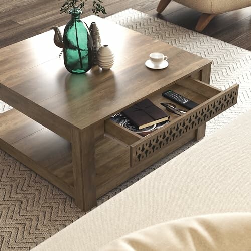 Wooden coffee table with open drawer containing books and remote.