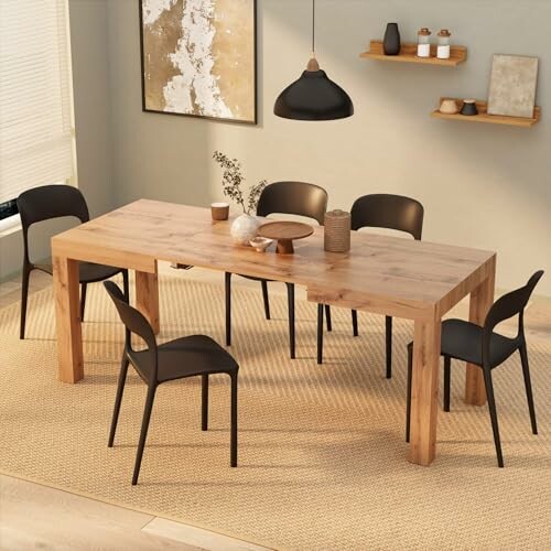 Modern dining room with wooden table, black chairs, and decor.