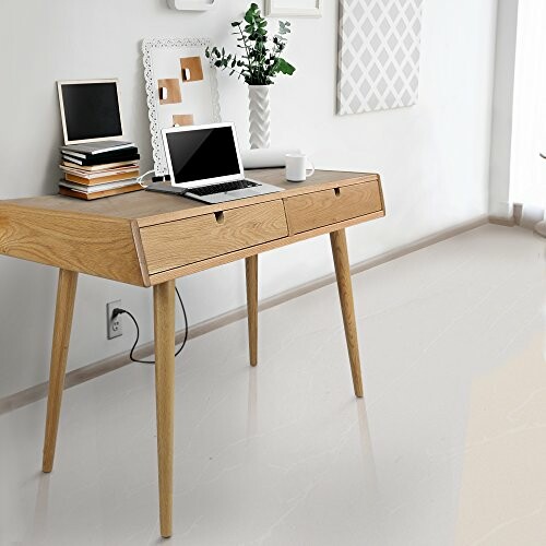 Modern wooden desk with a laptop, books, and decor items.