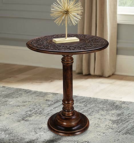 Ornate wooden accent table with decorative top and gold sculpture.