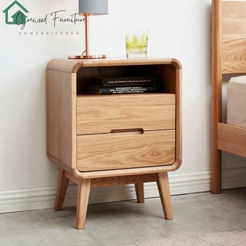 Wooden nightstand with two drawers and a glass on top.