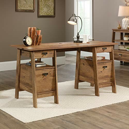 Wooden office desk with lamp and decor on a rug