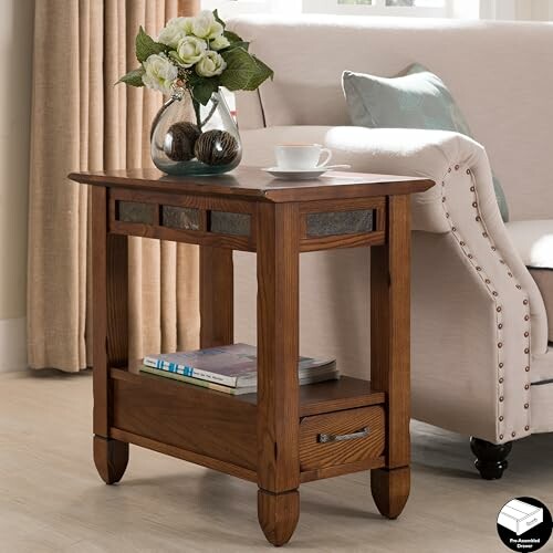 Wooden side table with a vase of flowers and a teacup.