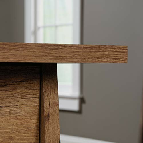 Close-up of a wooden table edge against a window background